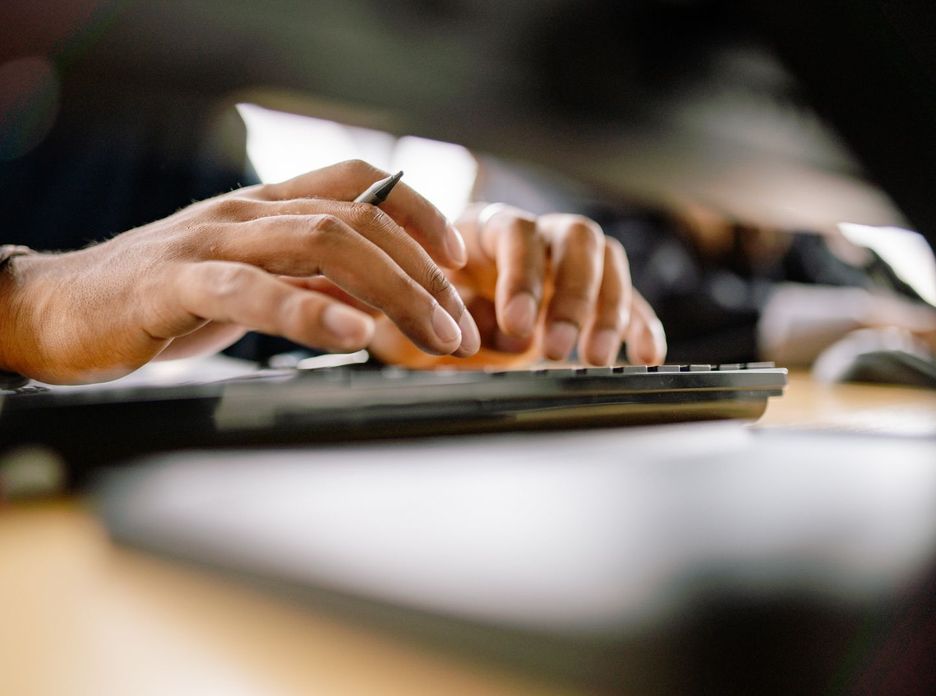 A detailed view of a person typing on a keyboard
