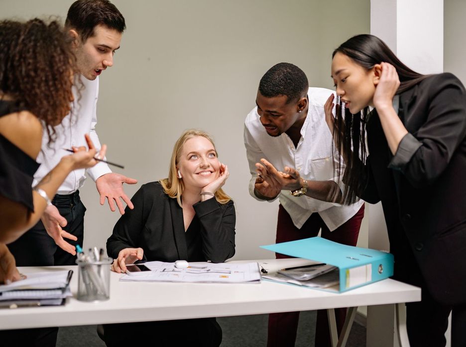 A diverse group of professionals engaged in an animated discussion at the workplace