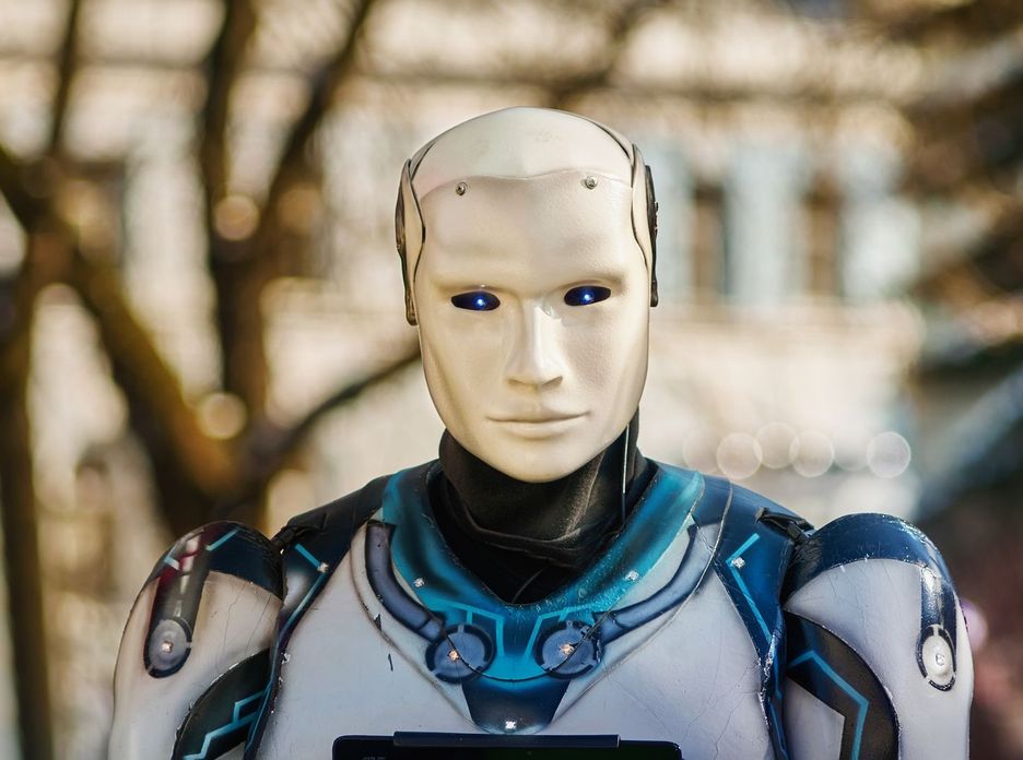Close-up of a humanoid robot with a futuristic design posing outdoors