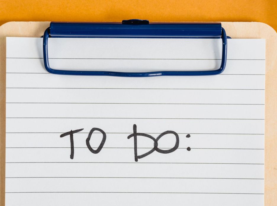 Clean and simple image of a to-do list on a clipboard with lined paper