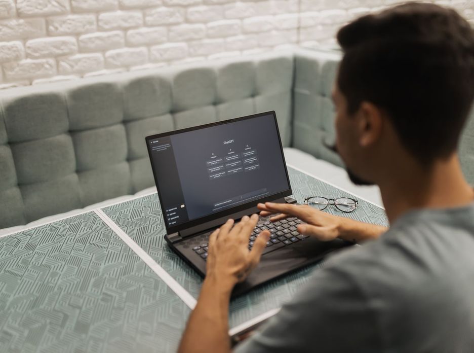 A man working on a laptop in a cozy, modern office space with a focus on technology