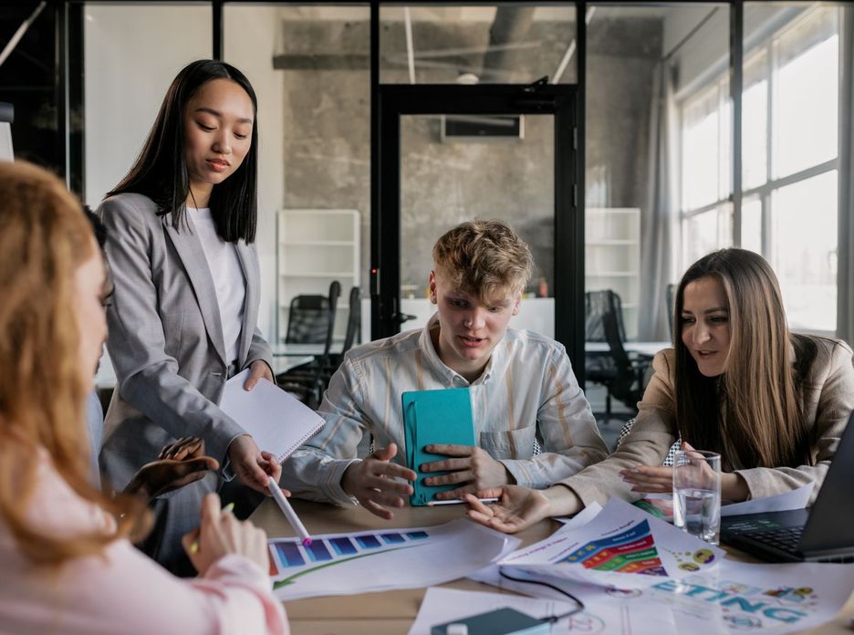 A diverse group of colleagues having a lively discussion around a conference table in a modern office