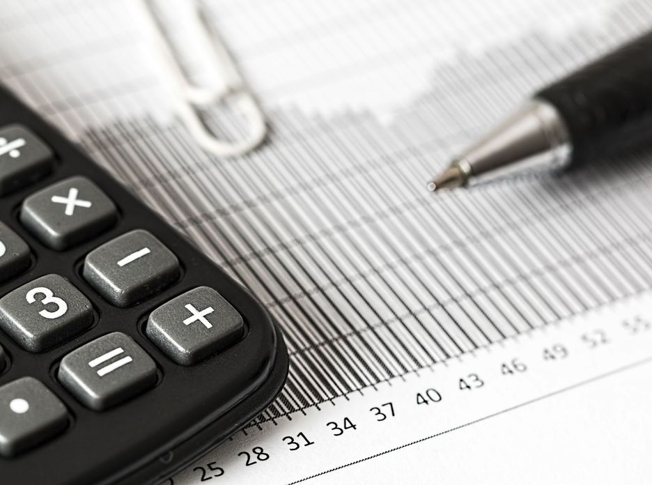 Calculator and pen on a printed table of figures
