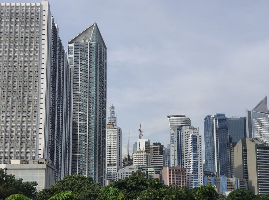 A vibrant modern city skyline featuring contemporary skyscrapers under a clear sky