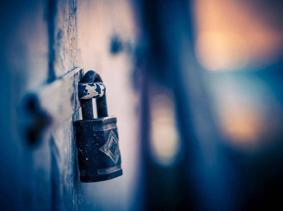 A padlock on a door against blurred lights