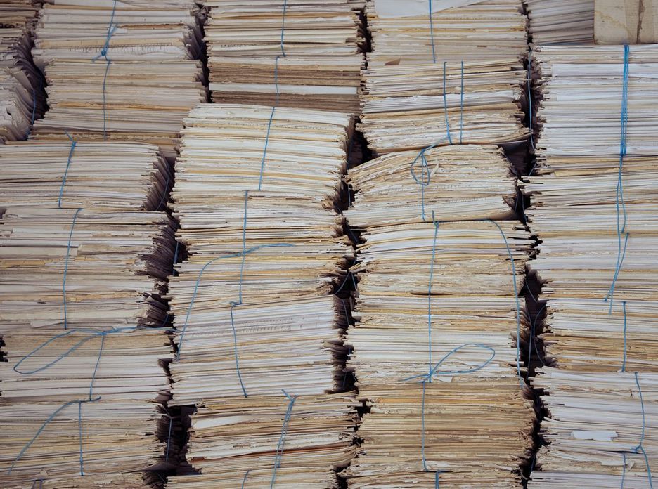 High stacks of organized, bound paper bundles create a structured and neat appearance